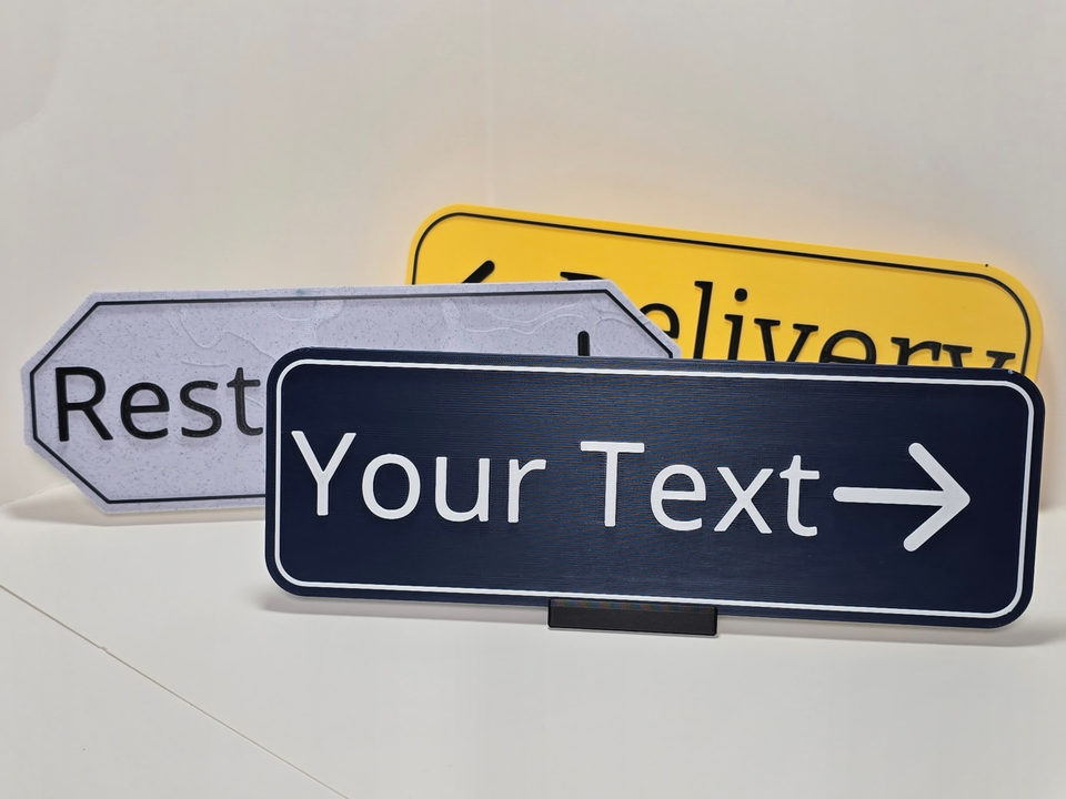 Tight front view of Delivery, Restroom, and Your Text directional sign samples on tabletop stands.