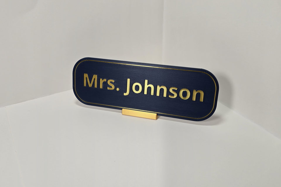 Navy blue and gold rounded Teacher and Staff Nameplate reading Mrs. Johnson on a gold tabletop stand.
