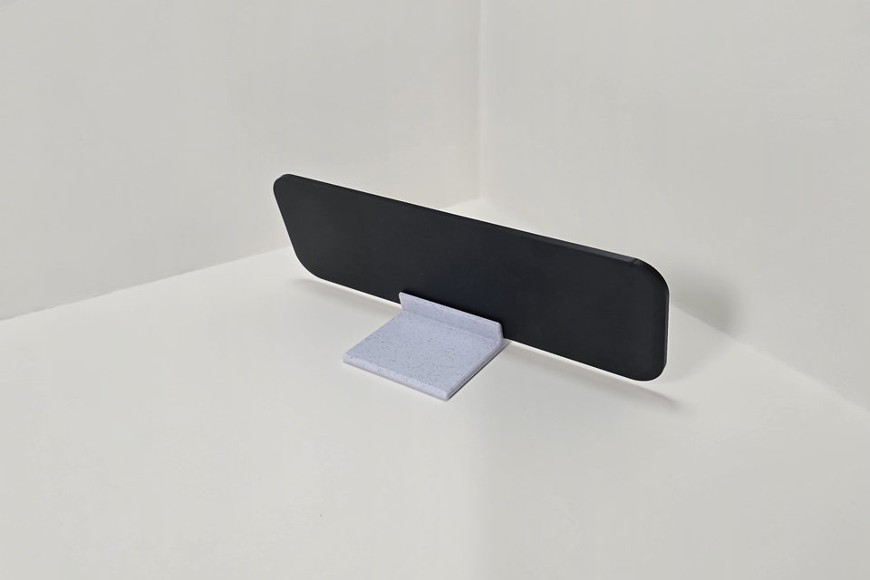 Rear view of a black desk nameplate seated in a marble-white tabletop stand.